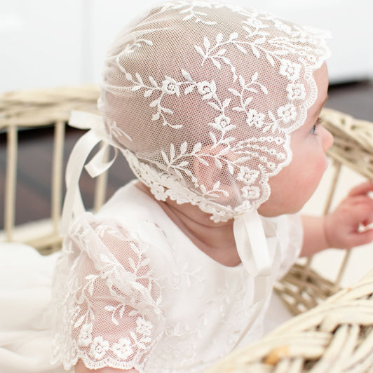 A closeup of a lace baby girl bonnet