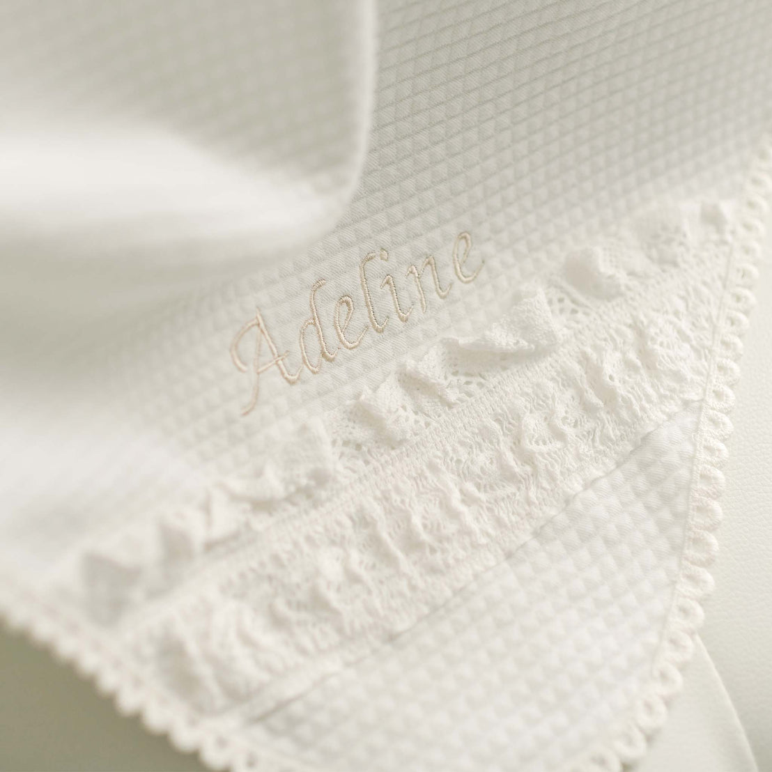 Alternate photo of the Adeline baptism blanket, with name personally embroidered in corner.