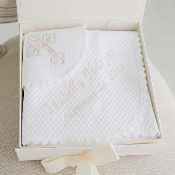 A white embroidered Baby Girl Blessing Gift Set with lace trim, personalized with the name "Isabella Stewart" and the date "November 28, 2021," displayed in an open box with a cream ribbon by Baby Beau & Belle.