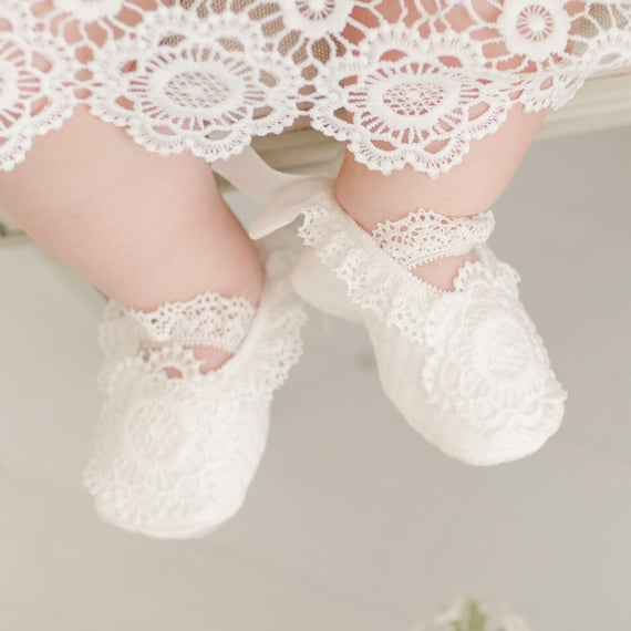 Baby girl wearing the Poppy cotton and lace baby booties. 