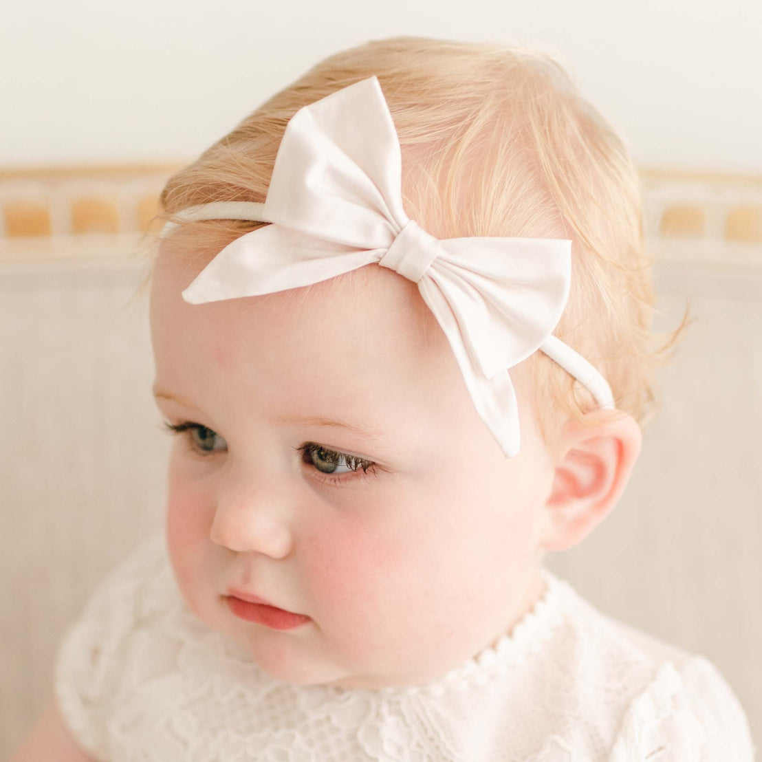 Baby girl wearing the Victoria Pink Bow Headband.