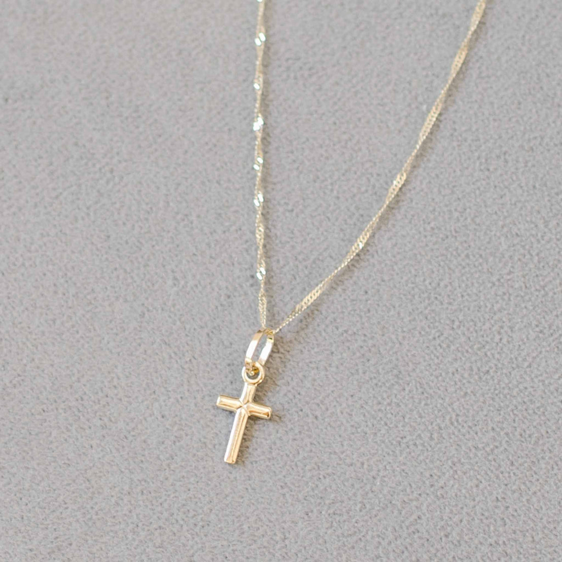 Small solid gold cross on chain