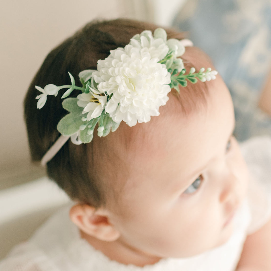 Baby girl wearing the white Emily Flower Headband.