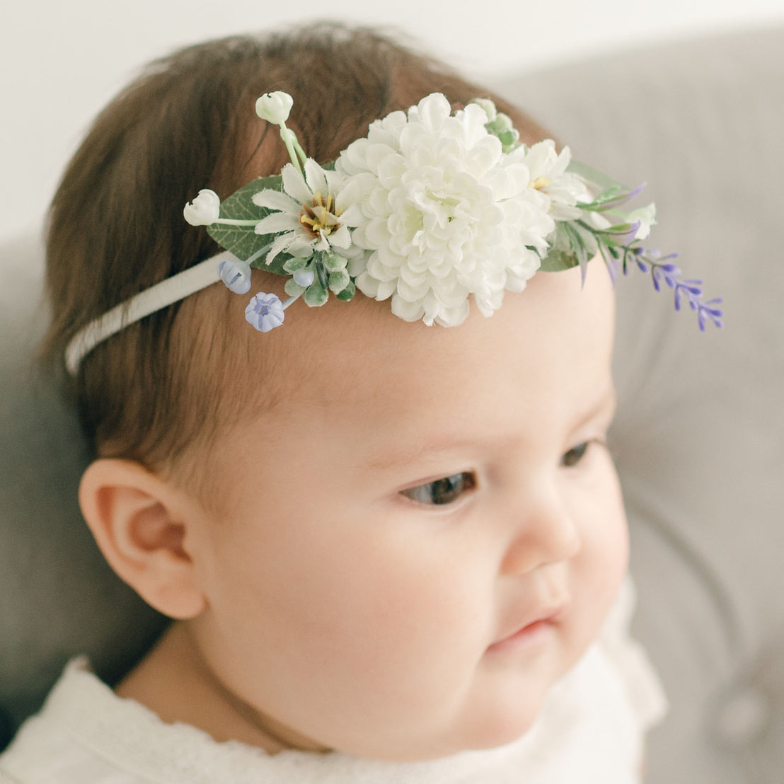 Baby girl wearing the heather Emily Flower Headband.