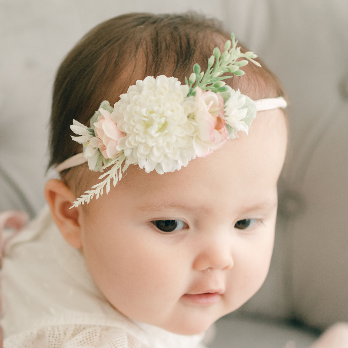Baby girl wearing the mauve Emily Flower Headband.