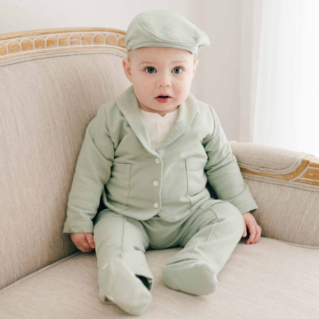 Baby boy sitting in Milo Sage suit