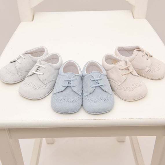 A photo of three pairs of Ezra Suede Shoes. These are available in three colors: tan, sky blue, and dove grey 
