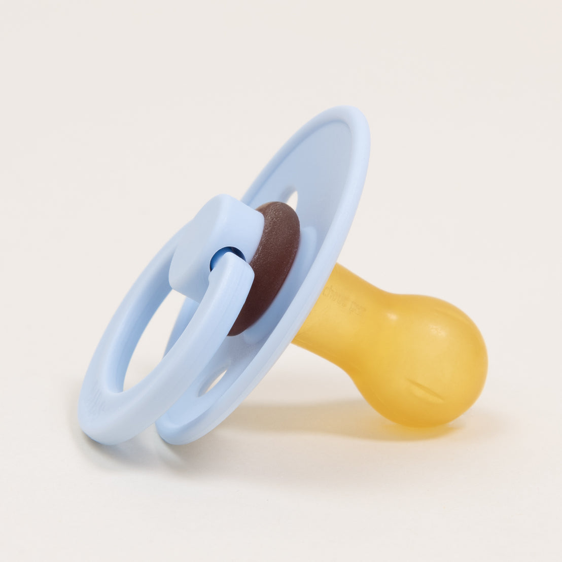 A Bibs Pacifier in Baby Blue with a light blue handle and a yellow natural rubber nipple, placed on a plain white background.