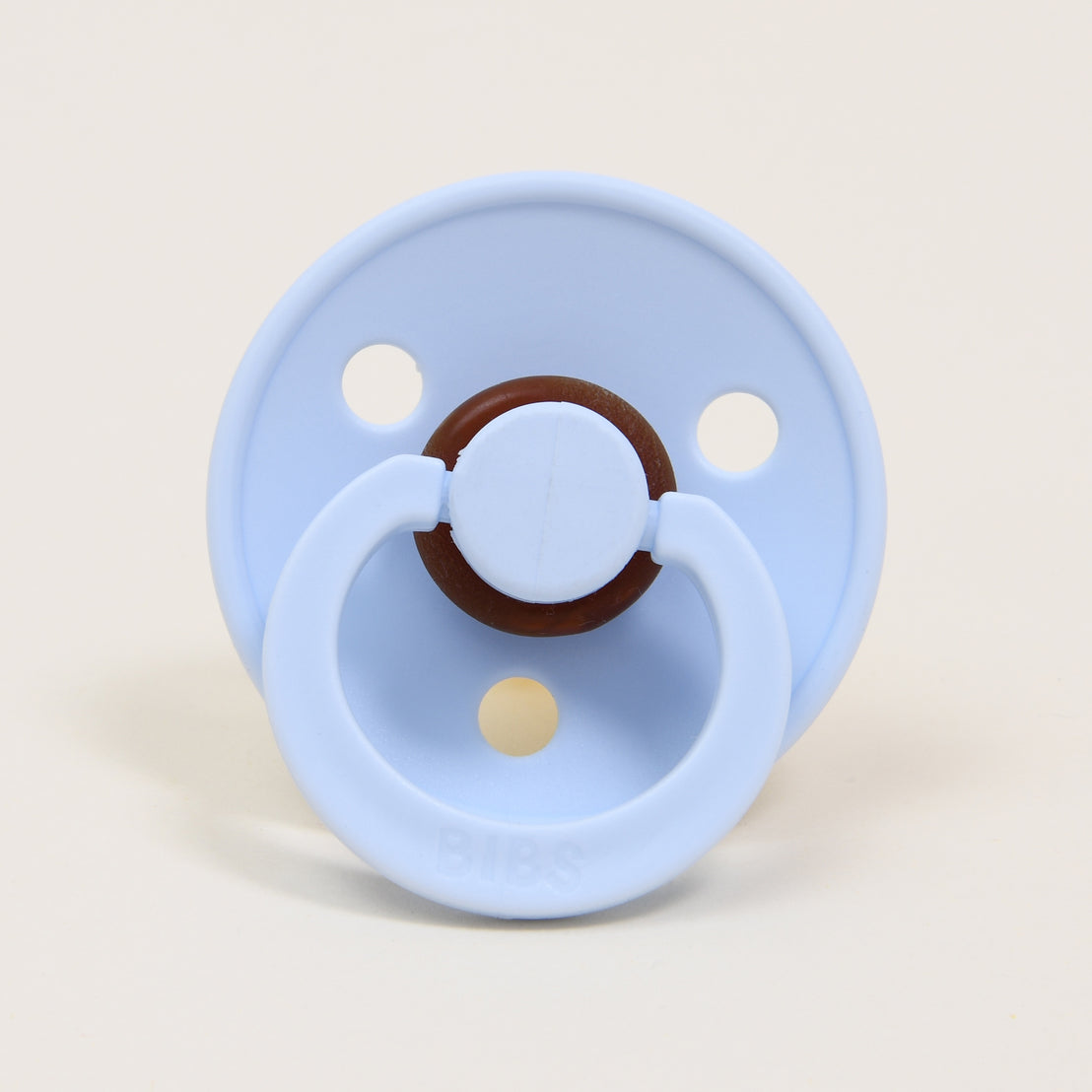 A closeup of a Bibs pacifier in Baby Blue, part of the Harrison Pacifier Set.
