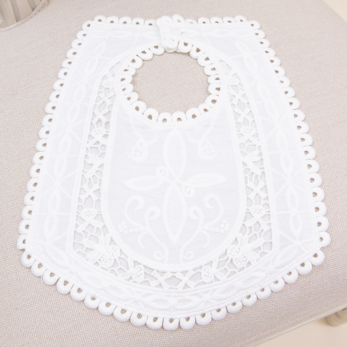 Flat lay photo of the Adeline baptism bib in cotton.