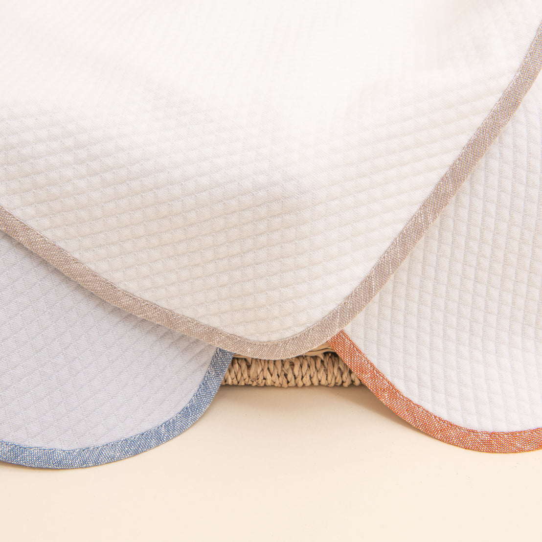 Close up photo of the three Silas Personalized Blanket corners, including the colors clay, sand, and indigo