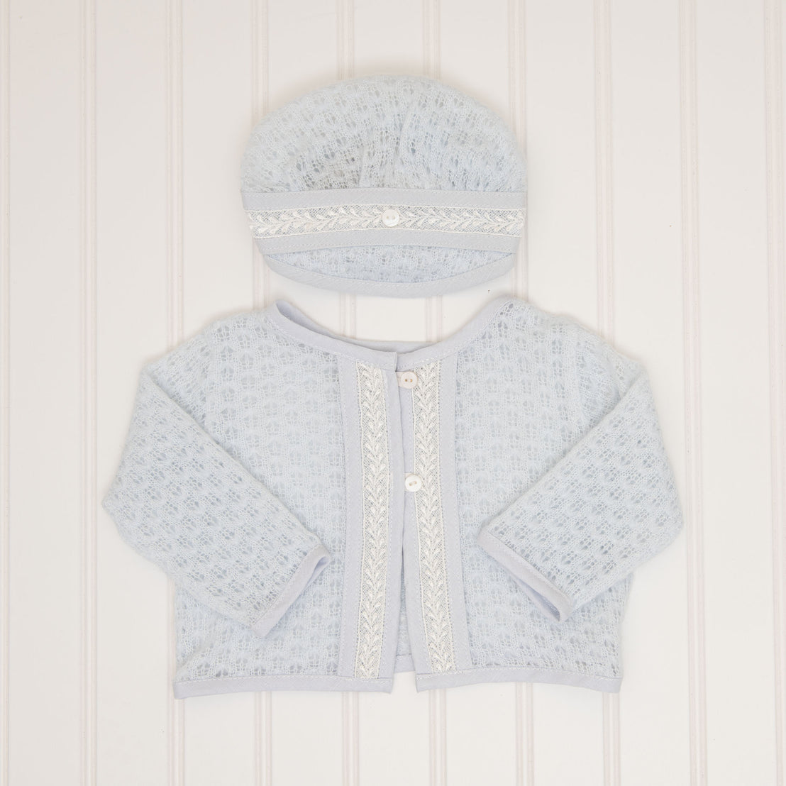 A flat lay of the Harrison Blue Knit Sweater and Blue Knit Hat