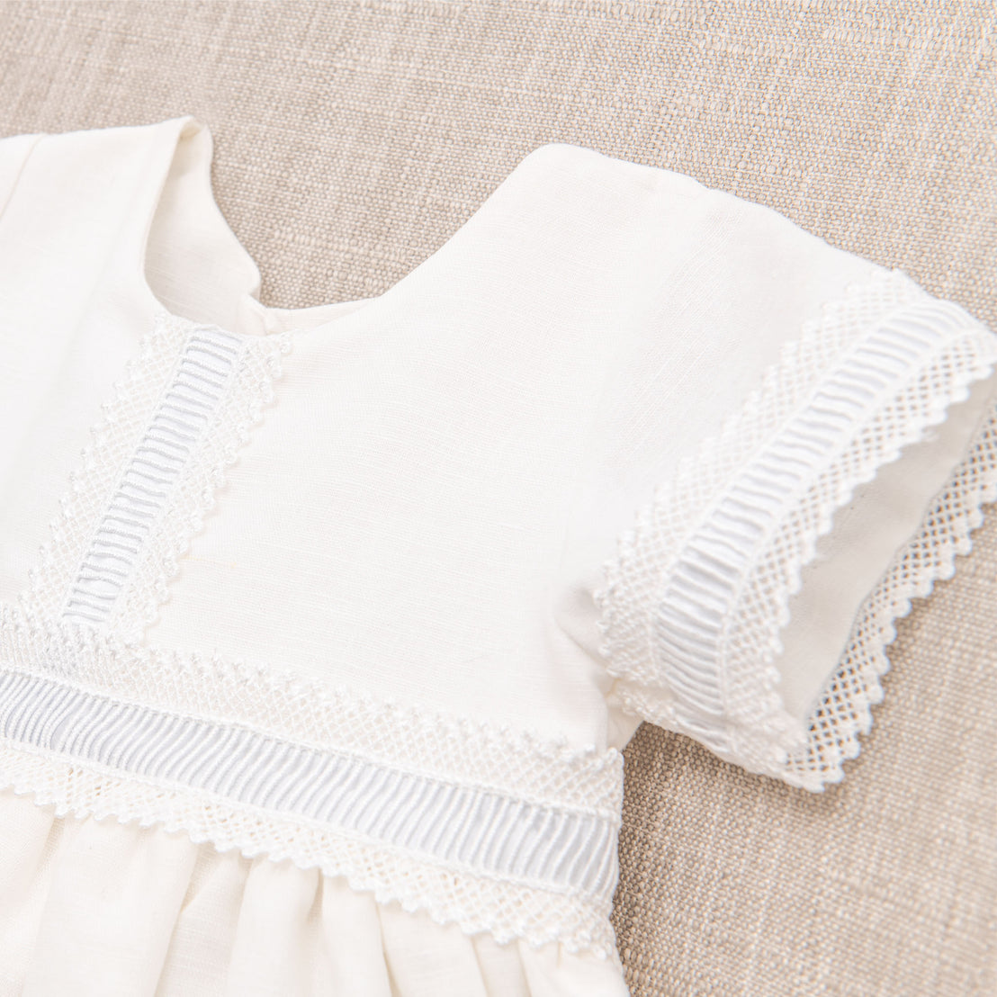 Close up photograph of the trim details on the Rowan linen boys baptism gown.