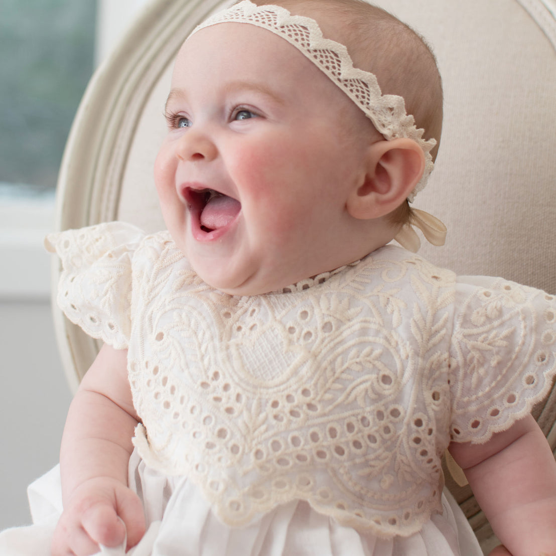 Baby laughing and wearing the Ingrid Tiered Gown and Headband 