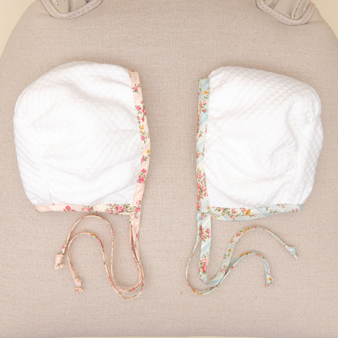 Flat lay comparison of the Eloise Quilted Bonnet in the colors "Blush" and "Powder Blue".