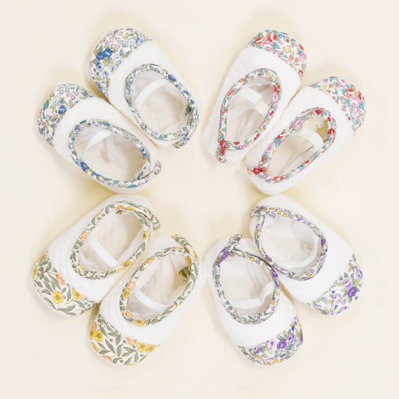 Petite Fleur Quilted Booties, arranged in a circle on a pale background, evoke an upscale boutique ambiance.