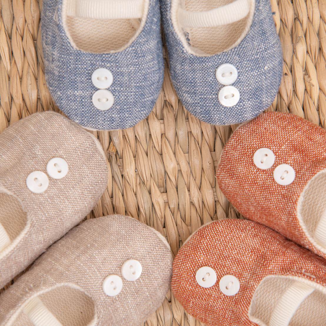 Close up flat lay photo of all three colors of the Silas Linen Booties, including the colors blue, tan, and red.