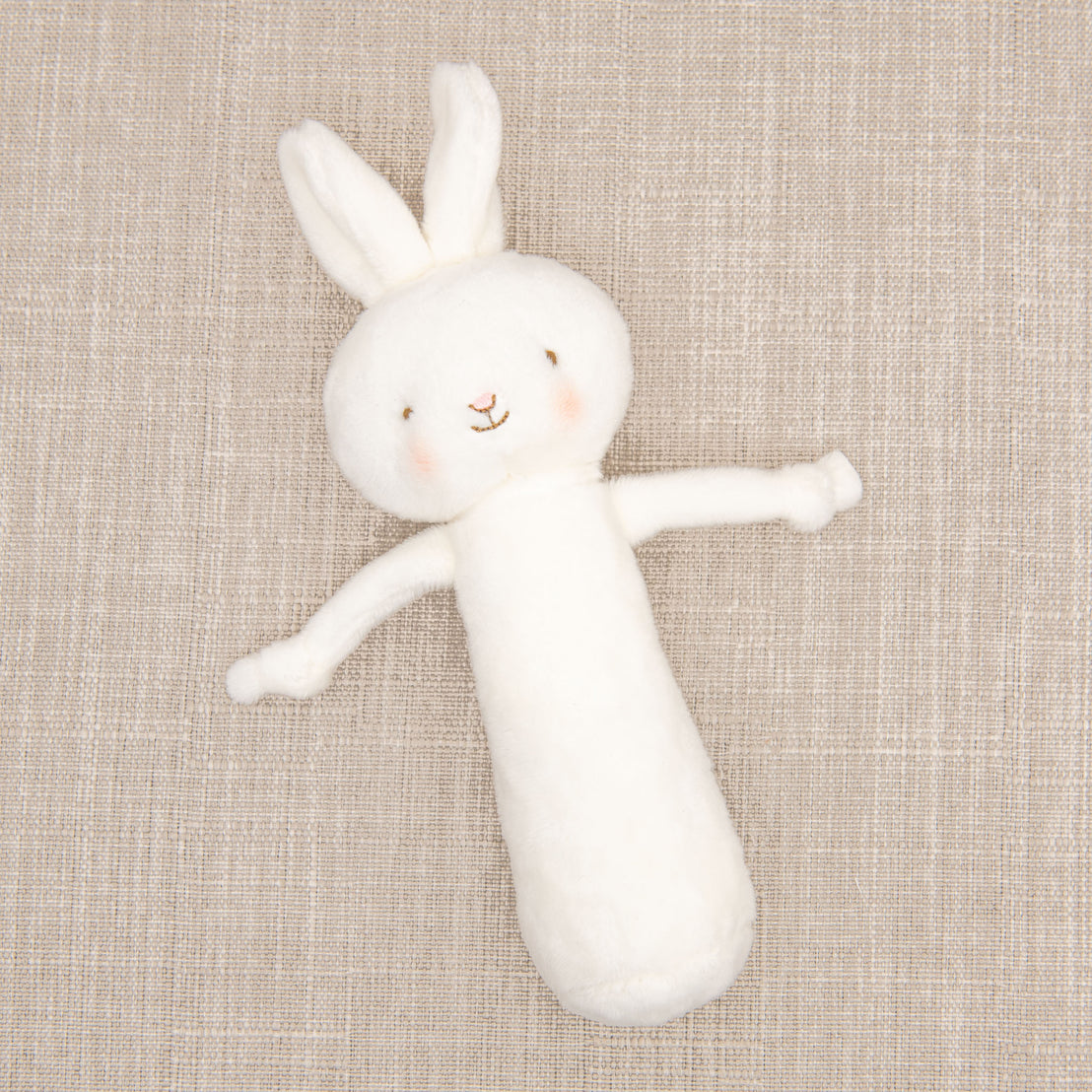 Flat lay photo of the White Bunny Chime Rattle.