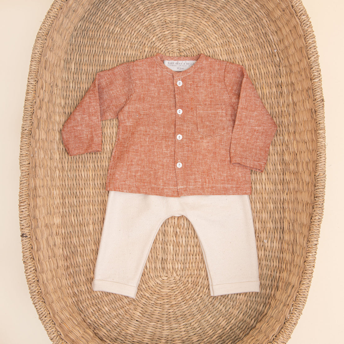 Flat lay photo of the red Silas Linen Shirt Set. It includes a linen collarless shirt paired with ivory french terry cotton pants