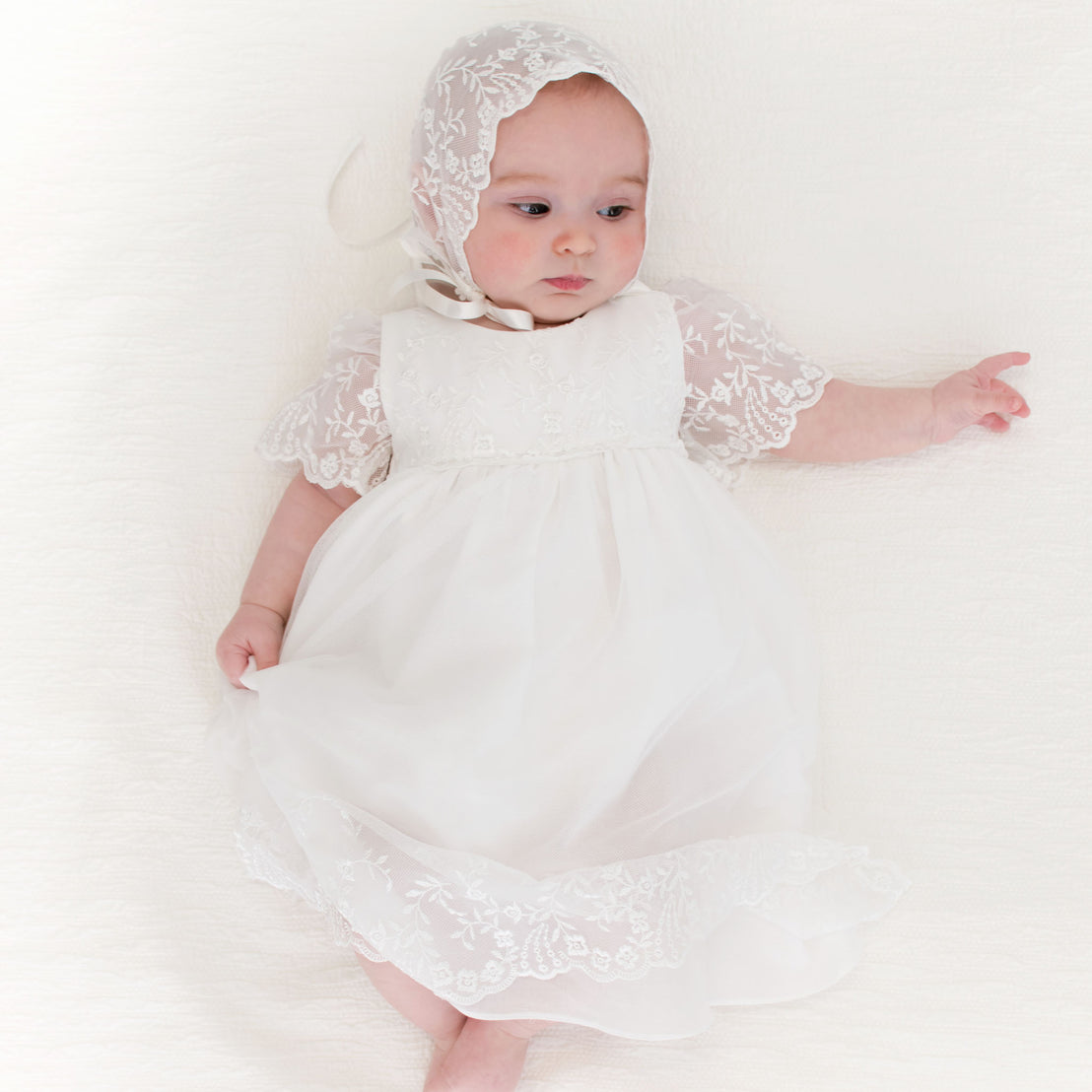 Alternative photo of baby girl wearing the Ella Lace Bonnet and Ella Romper Dress.