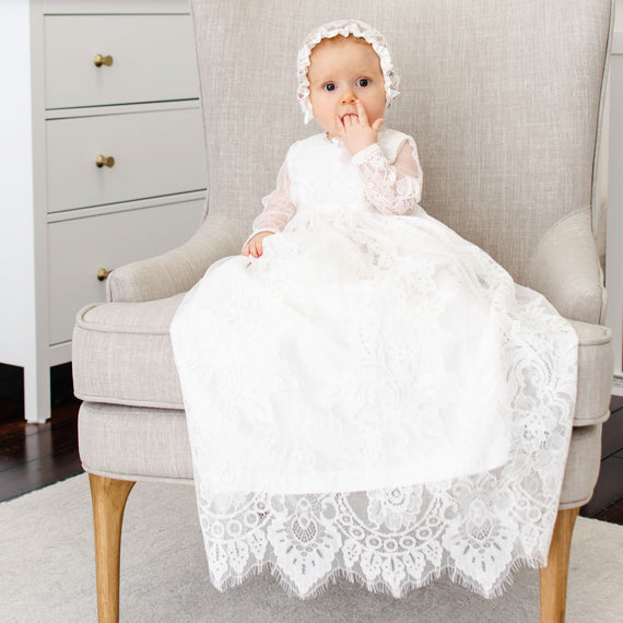 Baby girl wearing the long sleeve Victoria Christening Gown.