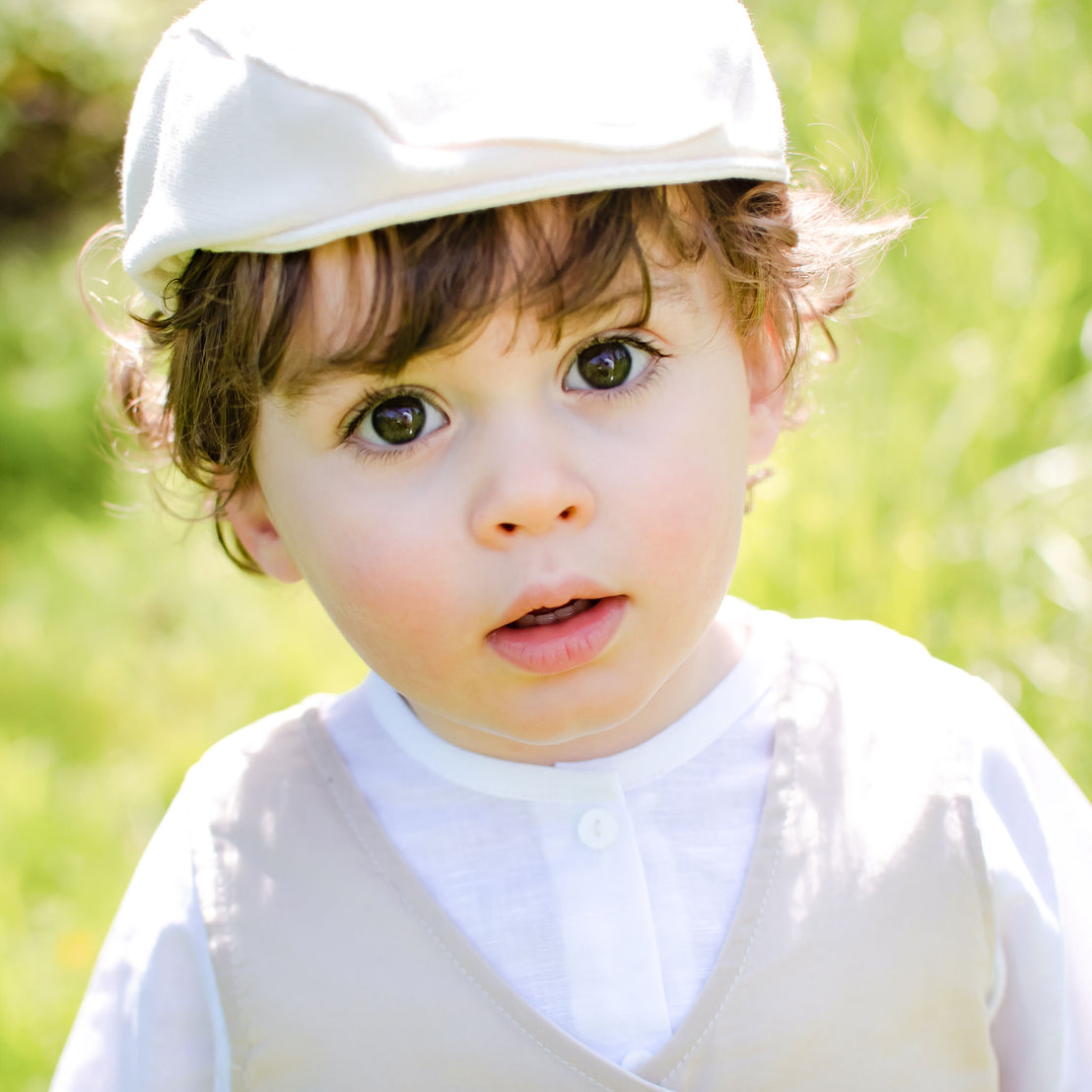 Photo of a baby outside wearing the Silas Vest Suit and matching Silas newsboy cap
