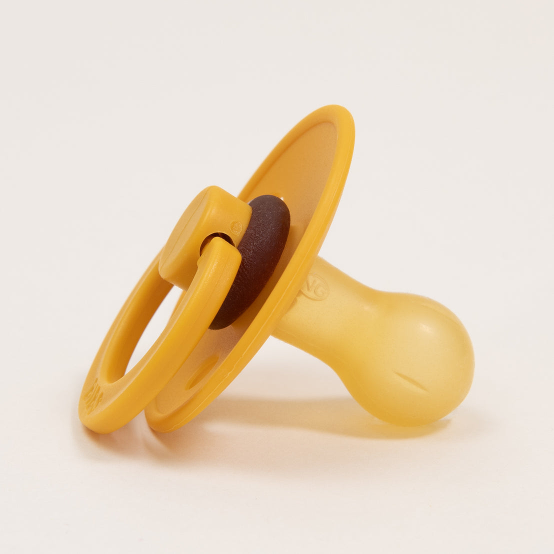 A yellow Bibs Pacifier in Honey Bee on a white background, featuring a round shield and a protruding handle. The nipple section is brown and attached centrally to the shield.