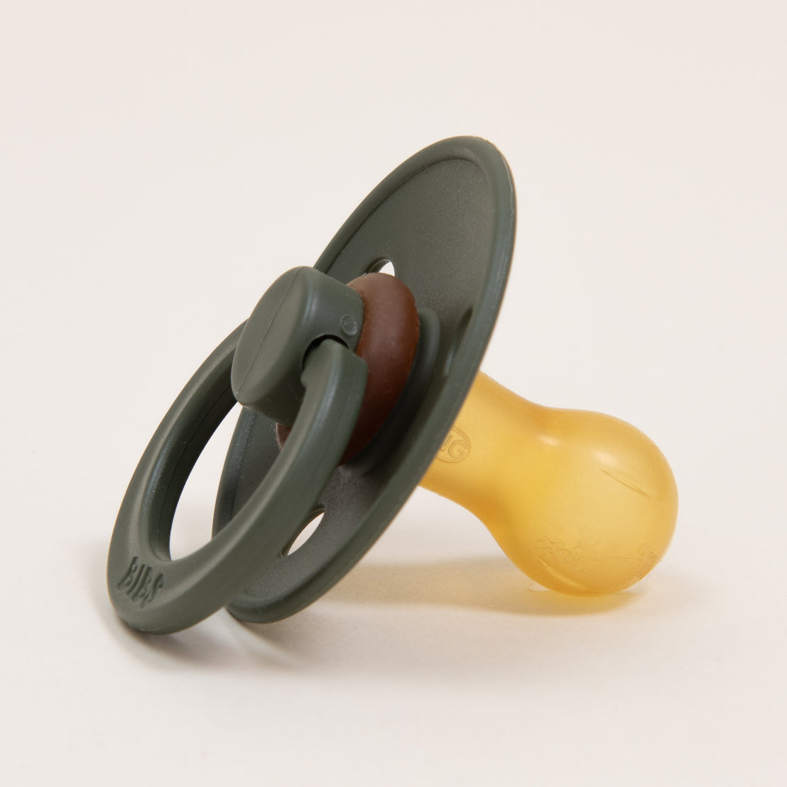 A close-up of a gray Bibs Pacifier in Hunter with a circular handle, set against a plain light background.