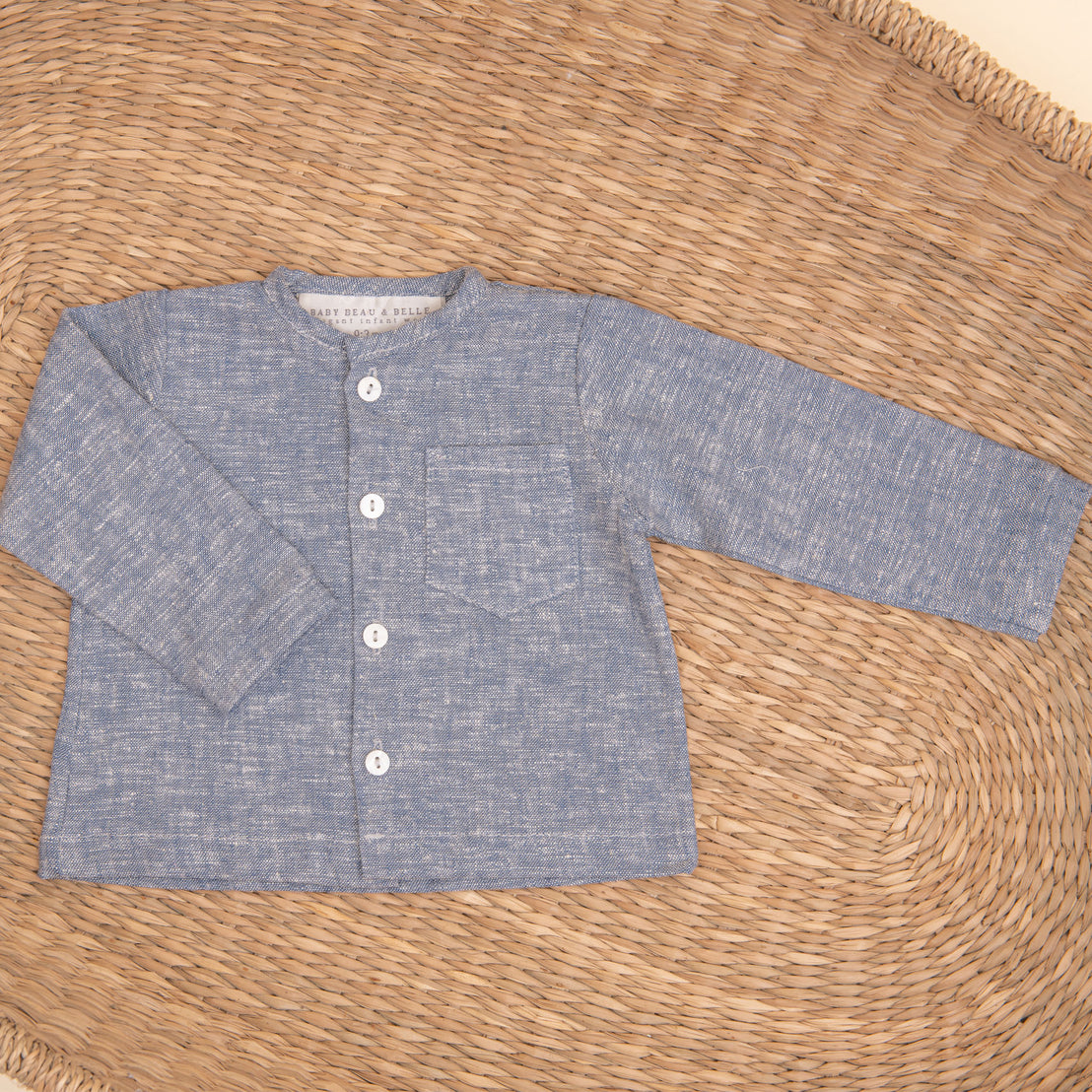 Flat lay photo of the indigo colored Silas Linen Shirt in a woven basket