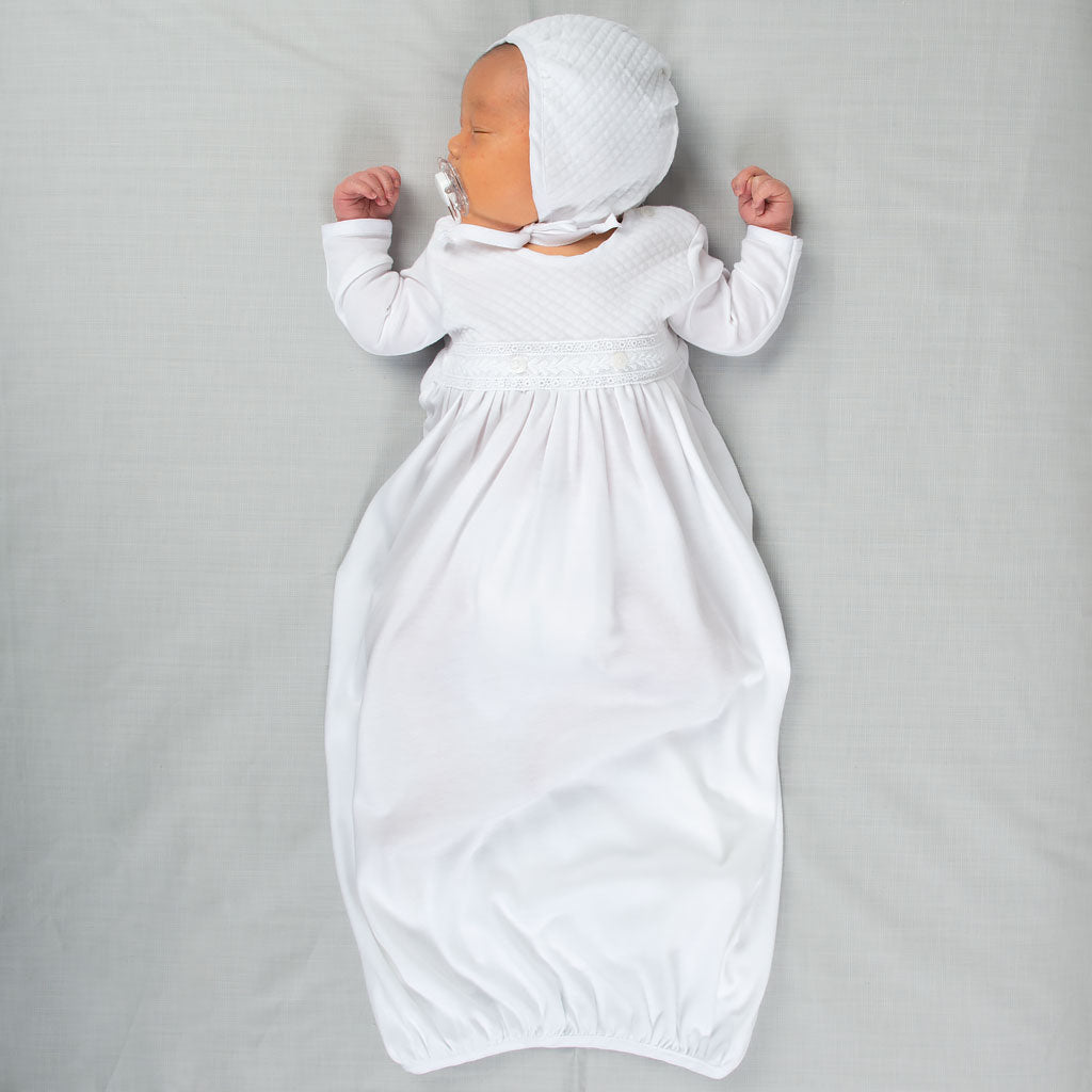 Photo of baby sleeping and wearing the Elijah Newborn Gown and Elijah Newborn Quilted Bonnet