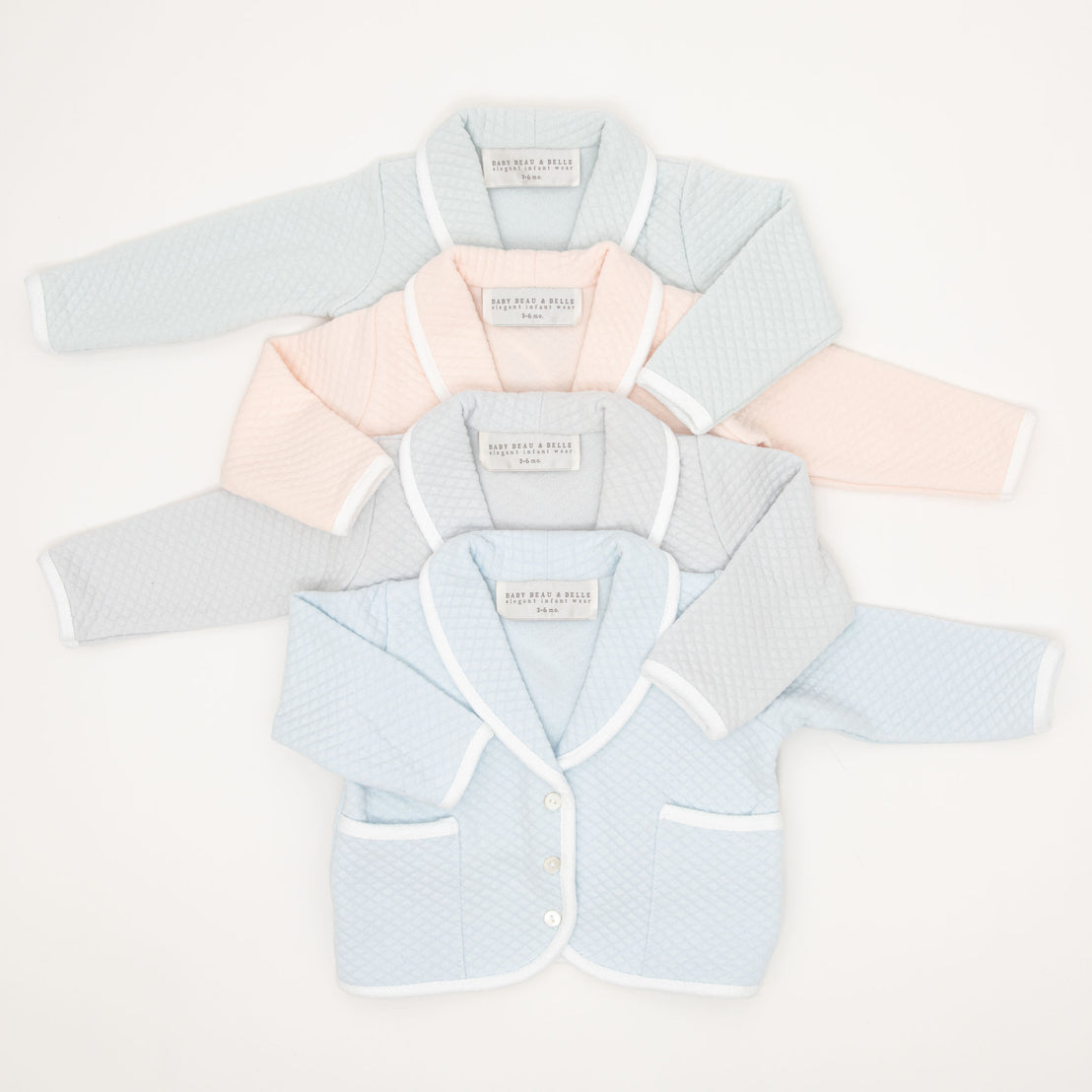 Flat lay photo of the four available colors that the Asher Baby Boy Jacket comes in, including grey, pink, powder blue, and soft teal.