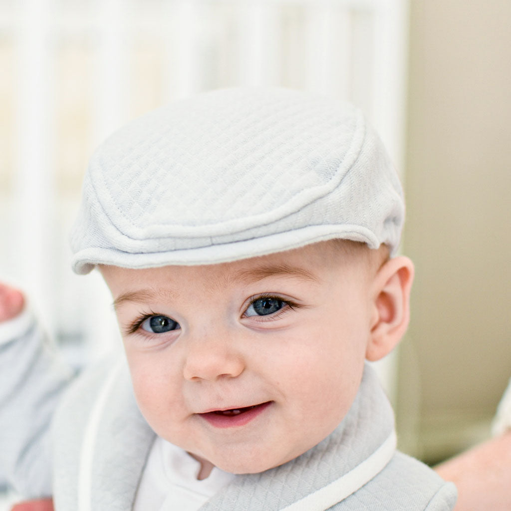 Cute baby boy wearing the Asher quilted newsboy cap.