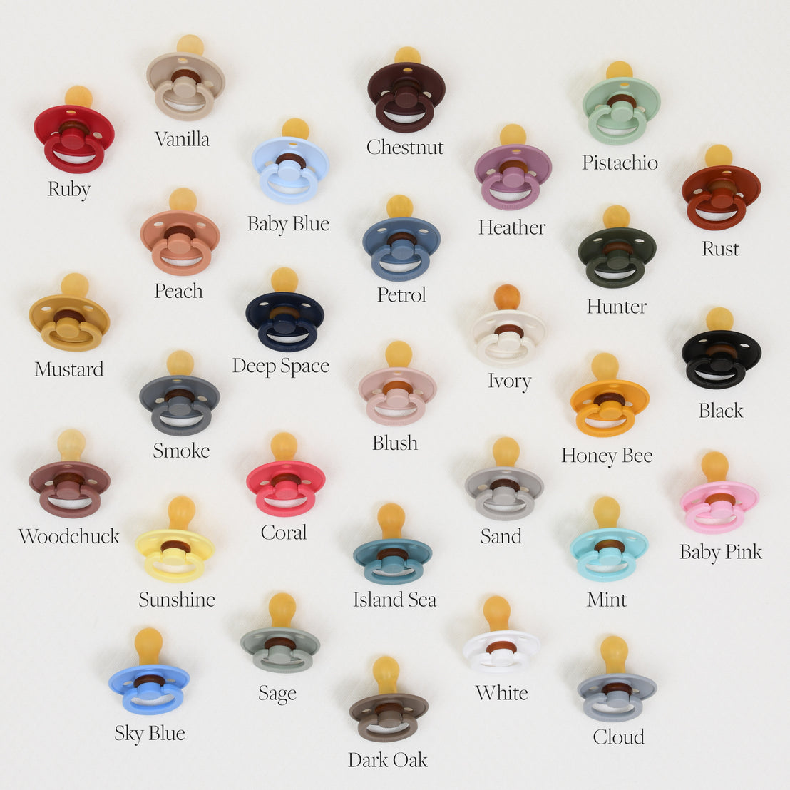 A grid of various colored Bibs Pacifiers on a light background, with each color labeled, such as ruby, vanilla, pistachio, deep space, and more.
