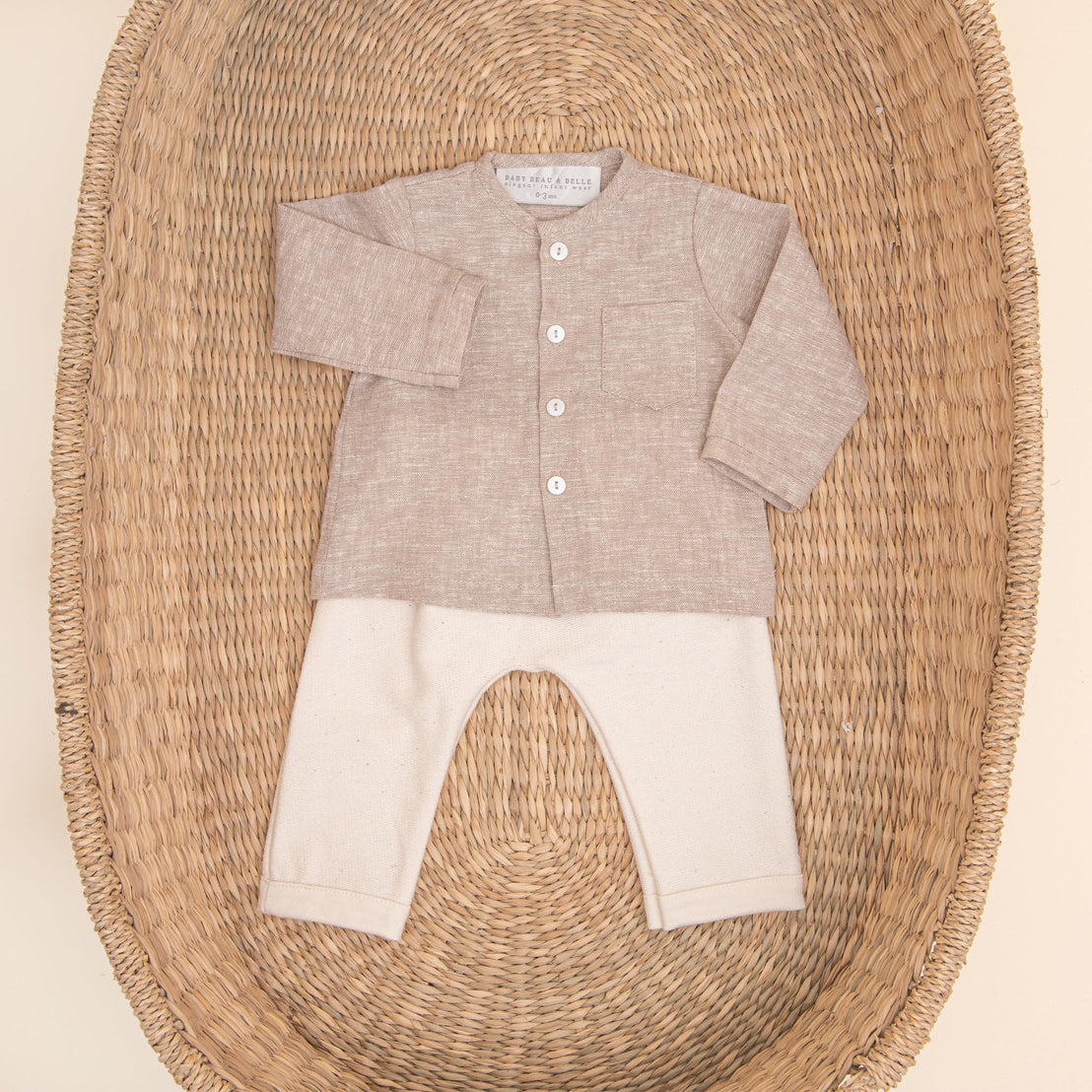 Flat lay photo of the tan Silas Linen Shirt Set. It includes a linen collarless shirt paired with ivory french terry cotton pants