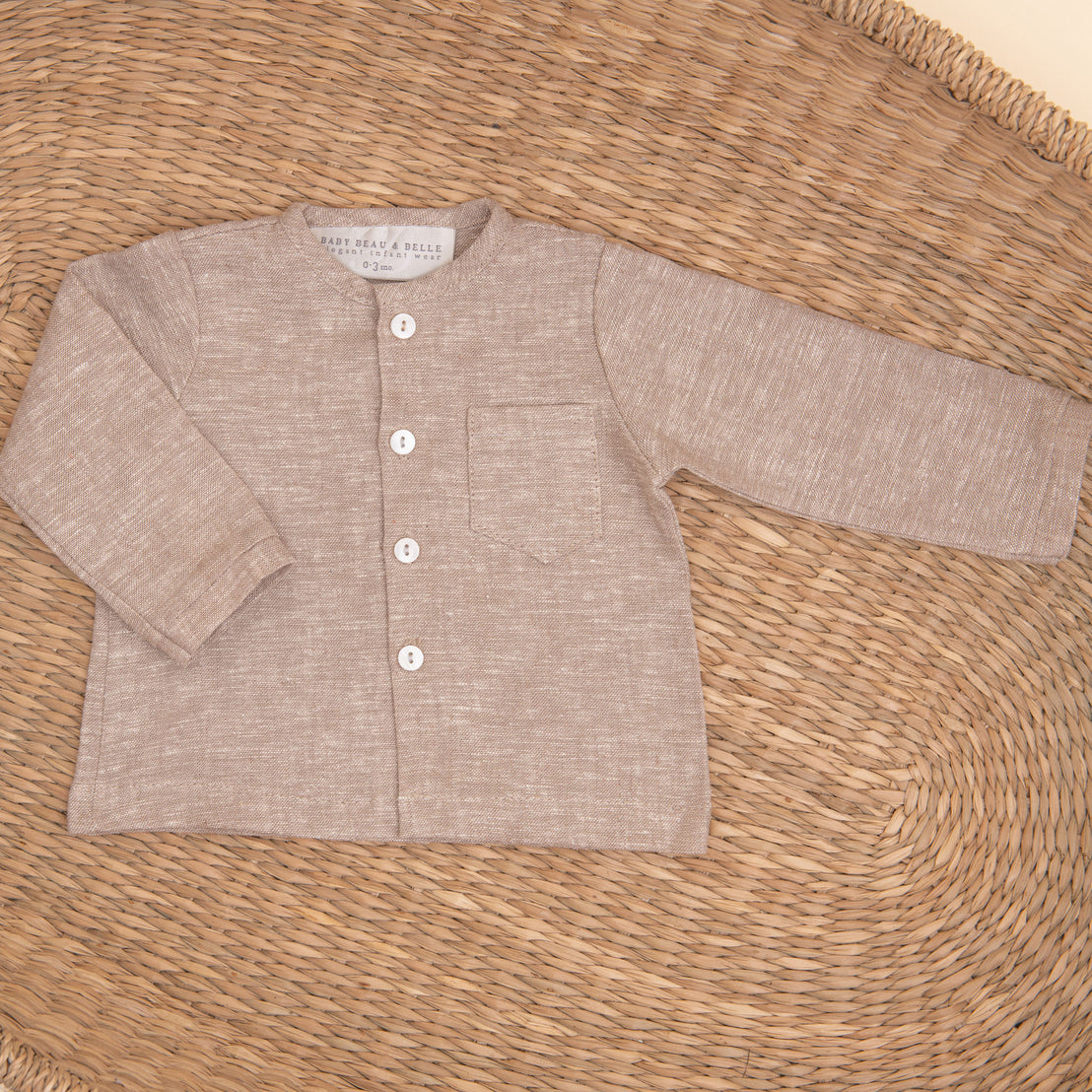 Flat lay photo of the sand colored Silas Linen Shirt in a woven basket