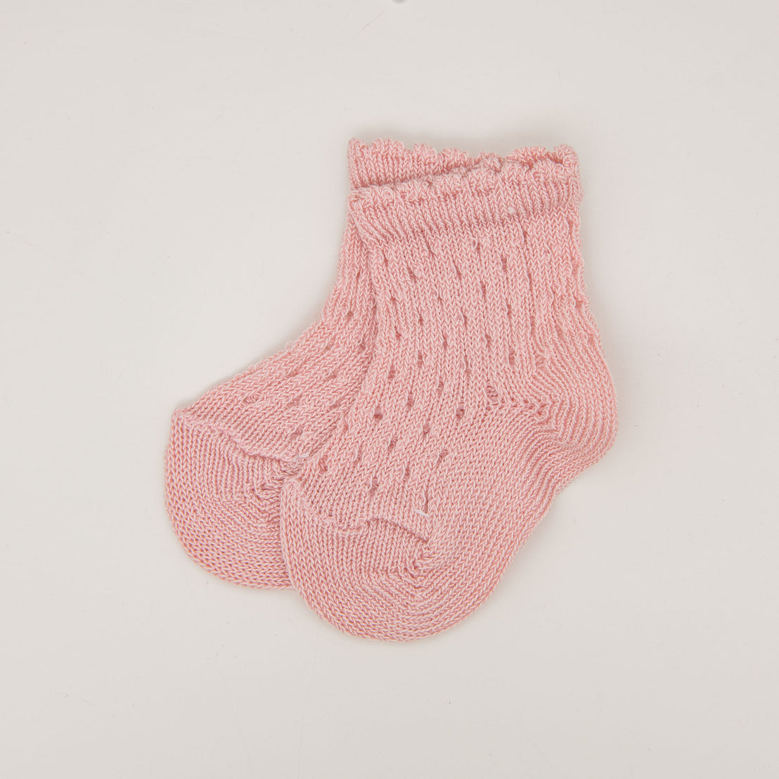 A pair of pink Scallop Edge Crochet Socks displayed on a plain white background.