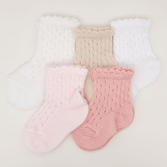 Five pairs of Scallop Edge Crochet Socks in white, beige, and pink, displayed in pairs on a light background. Each pair features a different knit pattern.