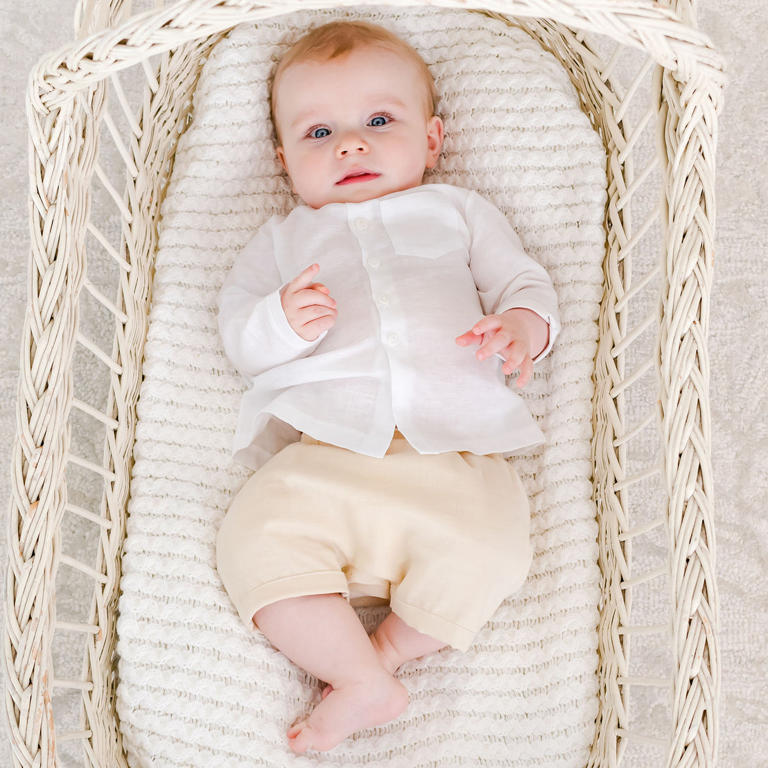 Baby boy in a crib wearing the Silas White Linen Shirt