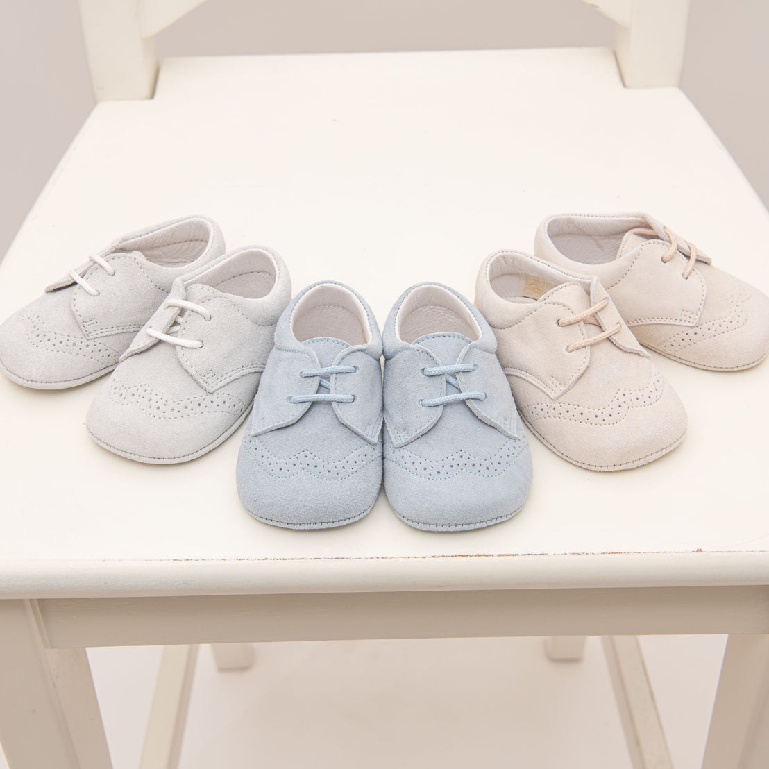 Flat lay photo color comparison of three Asher Suede Shoes, including dove grey, sky blue, and tan. 