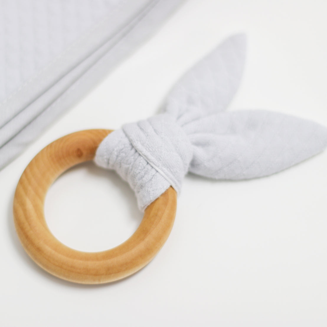 Close up photo of the Grayson wooden teether ring against a white backdrop.