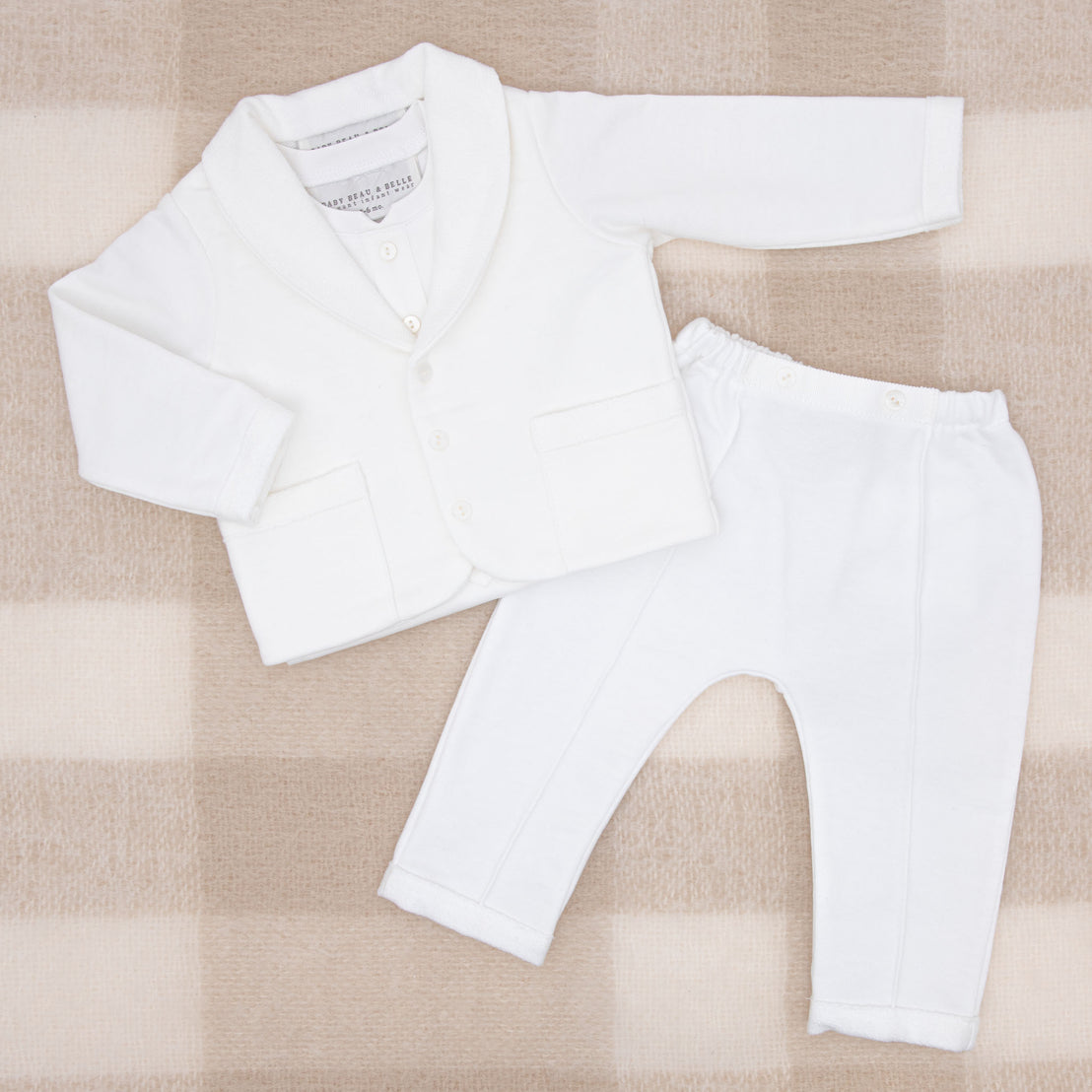 Flat lay photo of the Miles 3-Piece Suit, including the Jacket, Pants, and Onesie