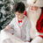 Toddler boy sitting with Santa asking for Christmas presents