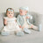 Two babies sitting on chair together 
