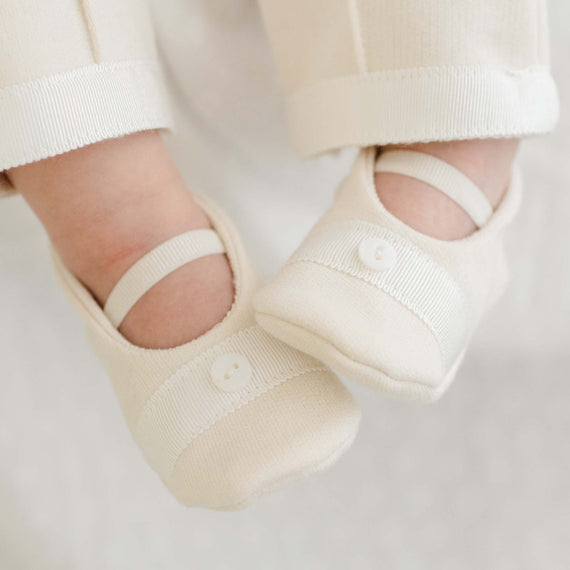 Photo of a baby wearing the Braden Booties made from ivory french terry cotton