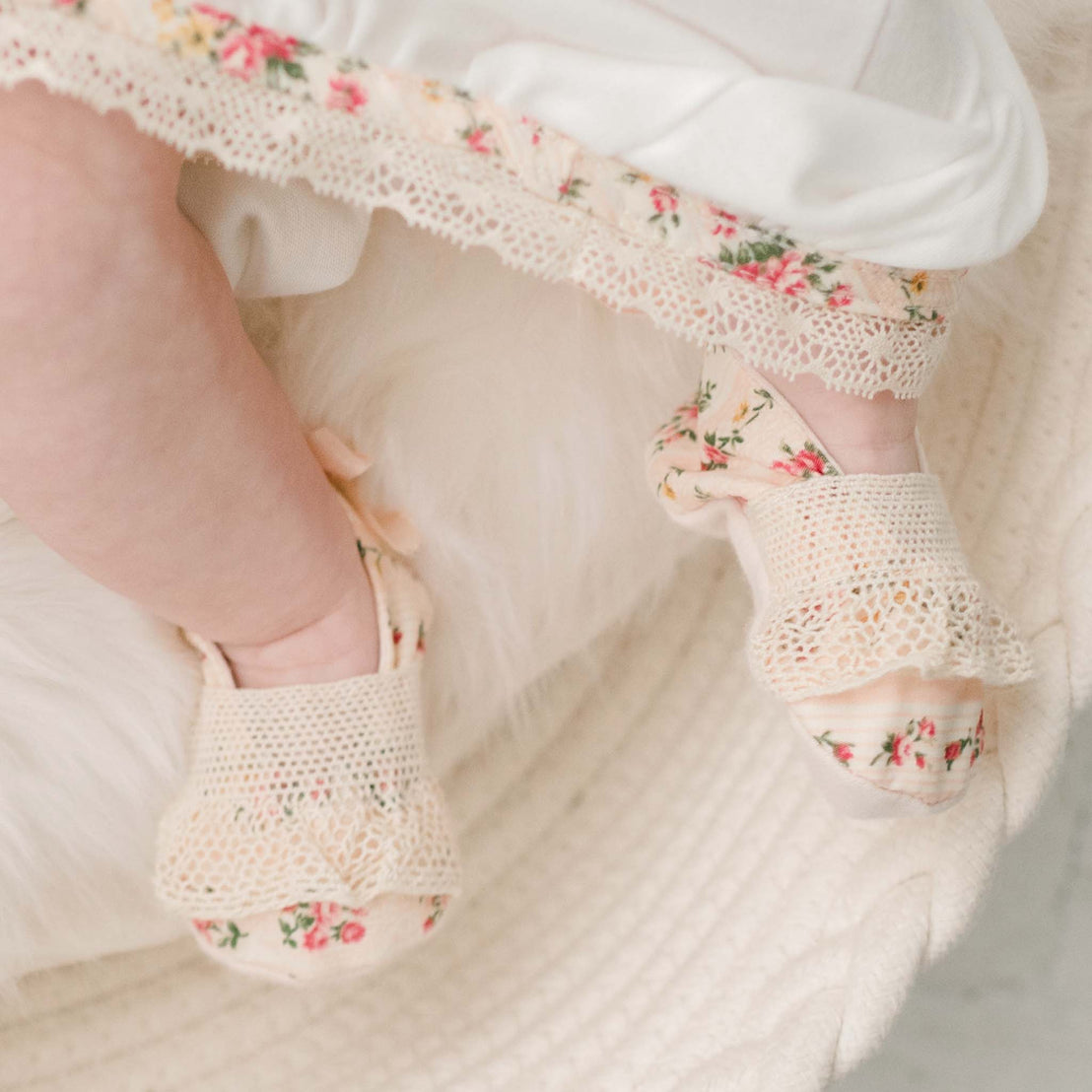 Closer detail of the "Blush" Eloise Booties made with the matching Eloise floral striped material and showcasing the natural color lace across the toe and a coordinating cotton ribbon bow on the heel.