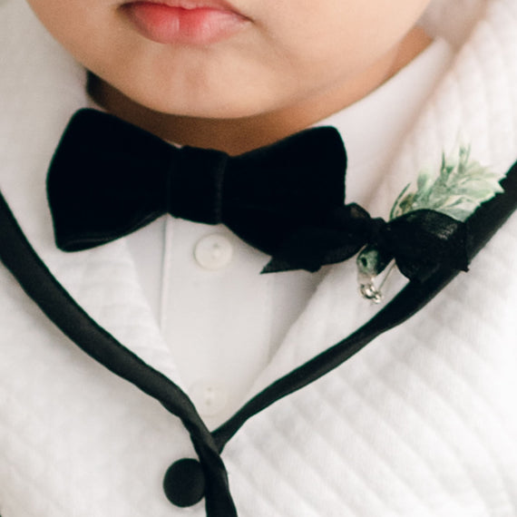 Baby boy wearing the James Bow Tie and Boutonniere on his white James Jacket.