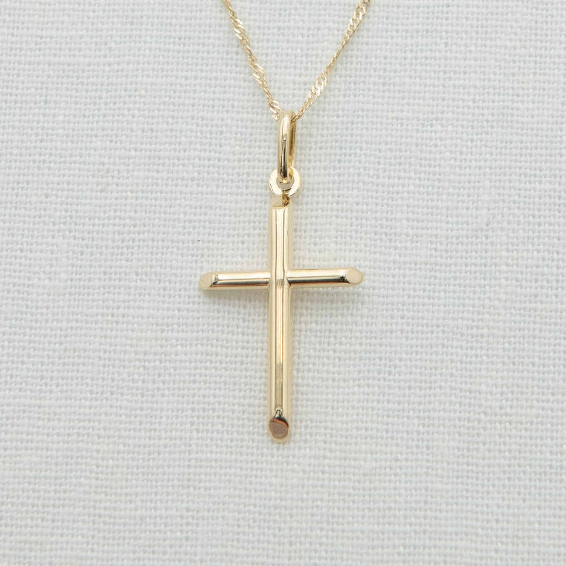 Cylindrical gold cross charm with chain