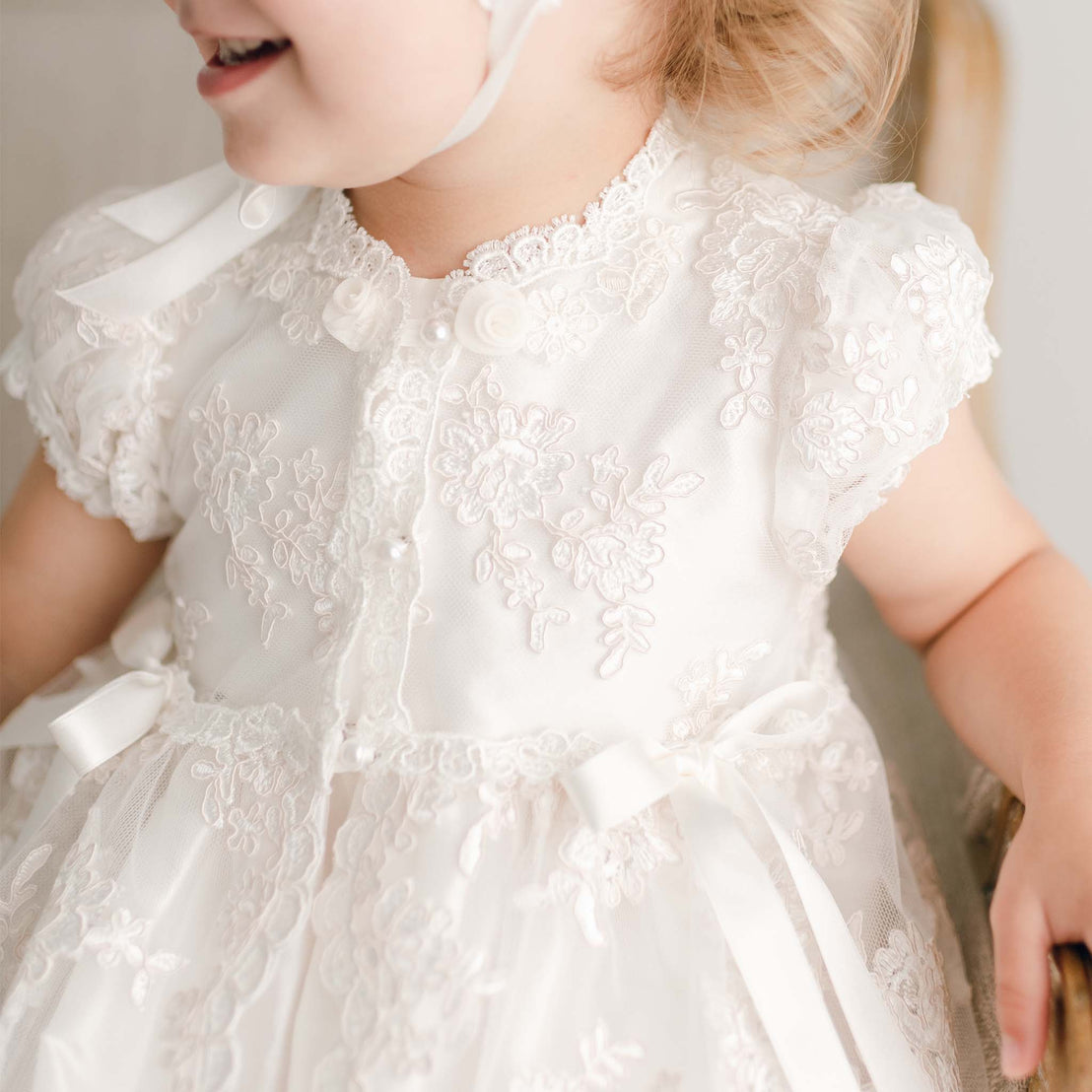 Close up of the details on the floral netting bodice of the Penelope baptism gown. 