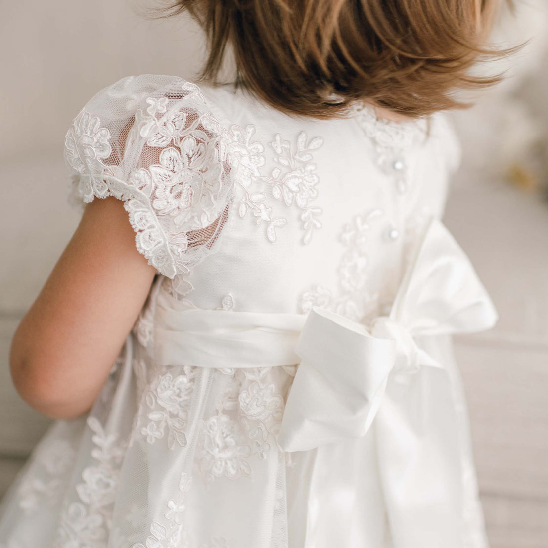 Close up detail of the back of the Penelope Silk Christening Dress with bow.