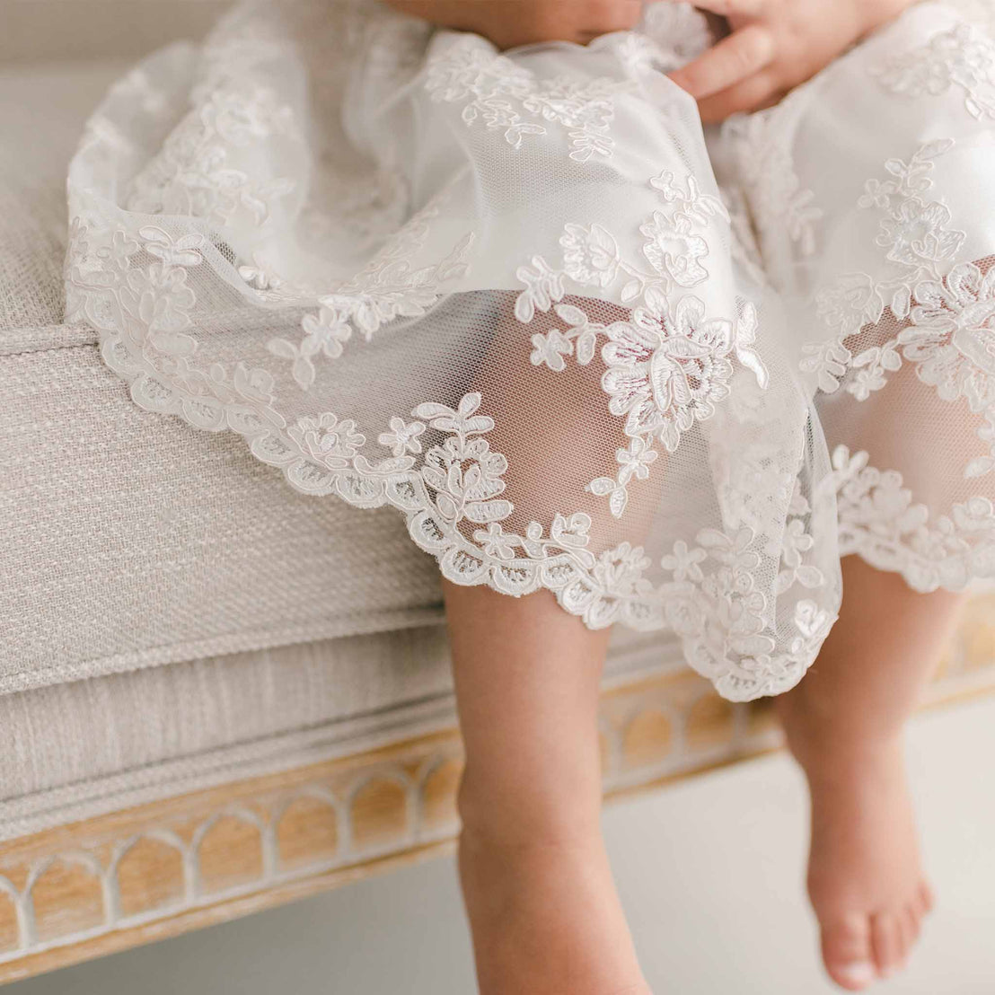 Close up photo of the hem of the Penelope lace christening dress.